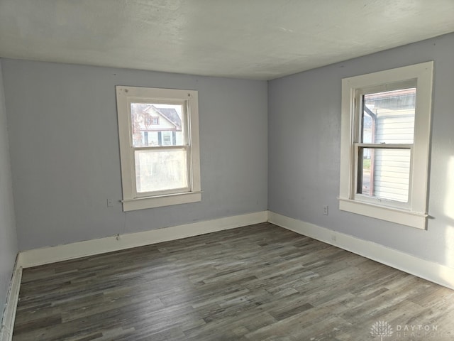 unfurnished room featuring dark hardwood / wood-style flooring