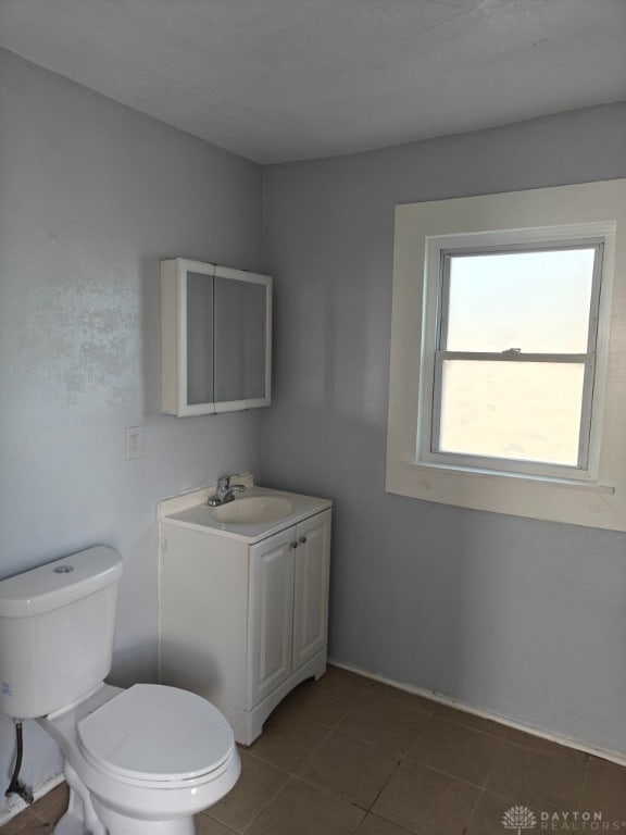 bathroom featuring toilet, vanity, and tile patterned floors