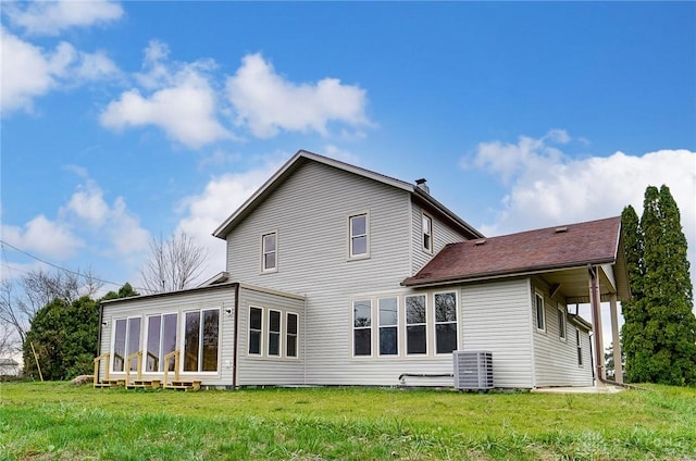 back of property featuring a lawn and cooling unit