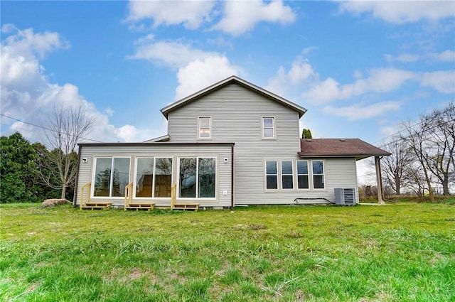 back of property featuring a yard and central AC unit