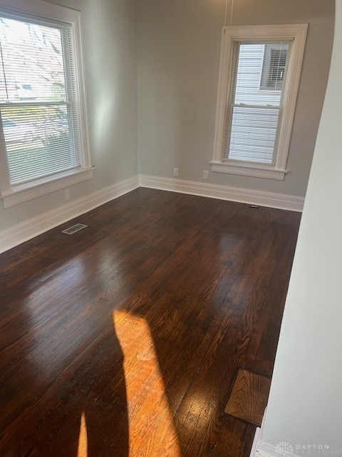 empty room with dark wood-type flooring