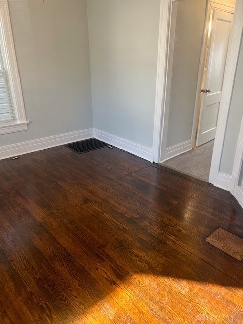 empty room featuring wood-type flooring