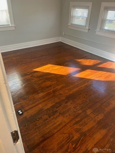 unfurnished room with dark hardwood / wood-style floors