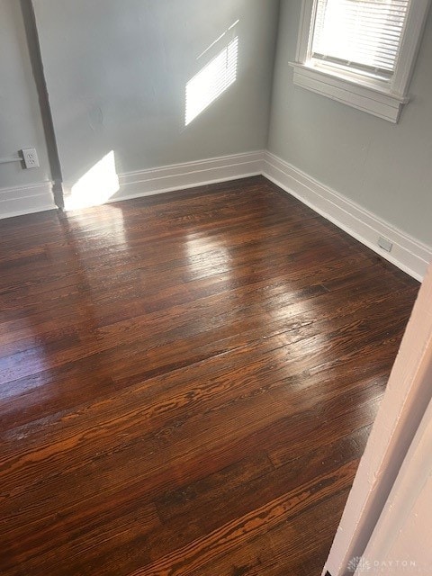 spare room with dark hardwood / wood-style floors