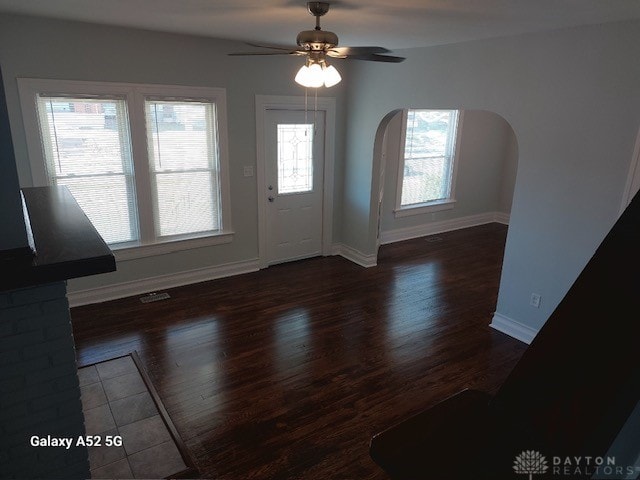 entrance foyer with ceiling fan, plenty of natural light, and dark hardwood / wood-style floors