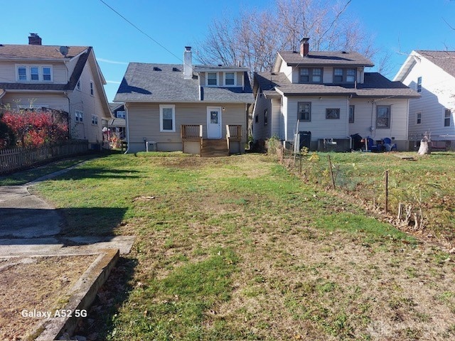 back of house with a lawn