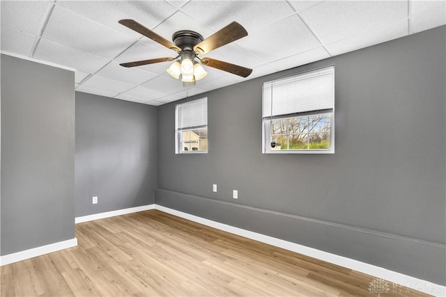 spare room featuring light hardwood / wood-style flooring, a paneled ceiling, and ceiling fan