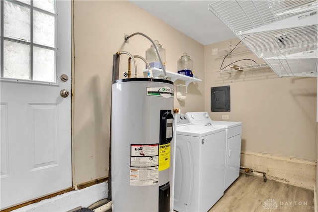 laundry room with separate washer and dryer, electric panel, electric water heater, and light wood-type flooring