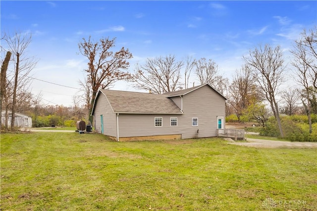 view of side of property featuring a yard and a storage unit