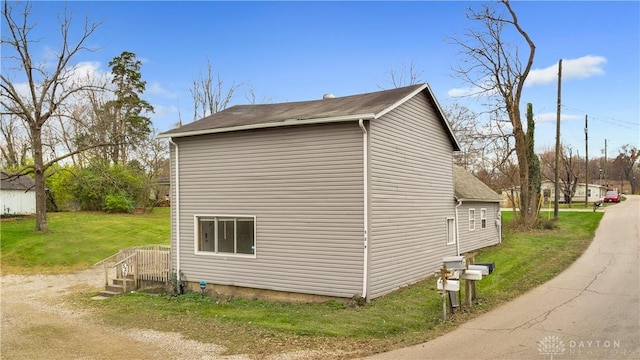 view of side of home featuring a yard