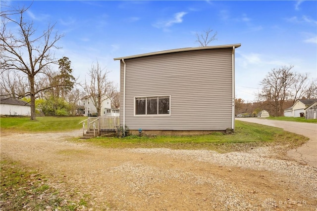 view of side of home with a yard