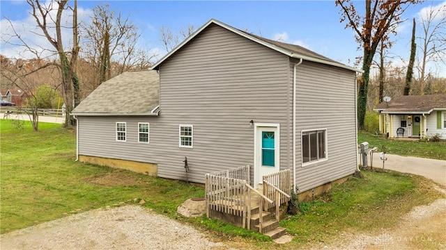 view of side of property with a lawn