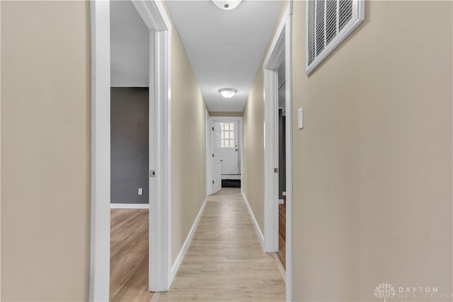 hall with light hardwood / wood-style flooring