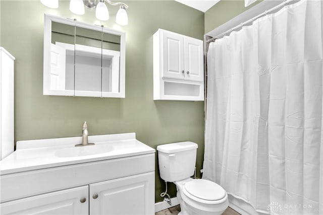 bathroom with vanity, a shower with shower curtain, and toilet