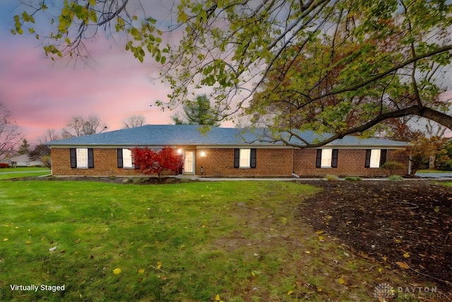 ranch-style house featuring a yard