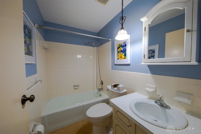 full bathroom featuring vanity, toilet, tile walls, and tiled shower / bath