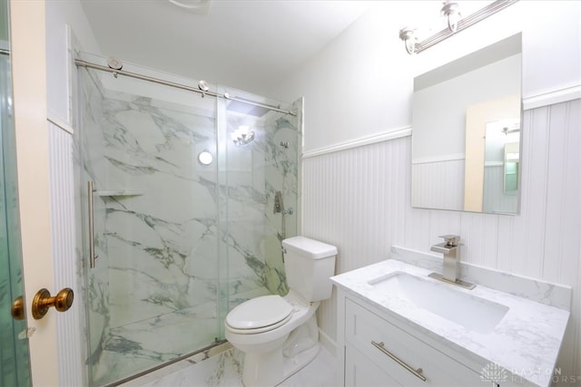 bathroom featuring vanity, an enclosed shower, and toilet