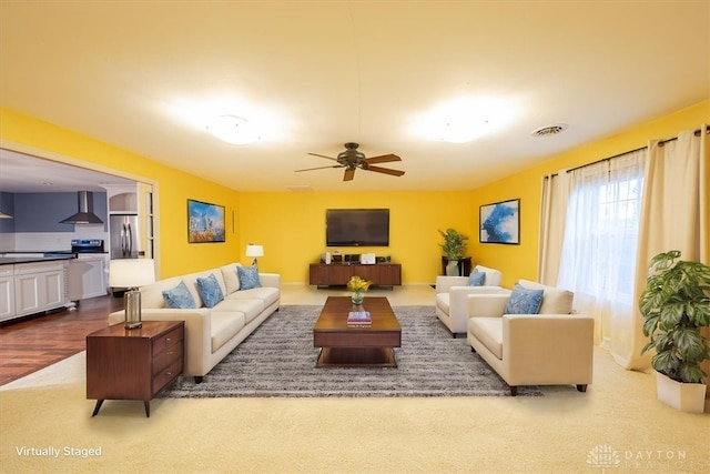 living room featuring ceiling fan and wood-type flooring