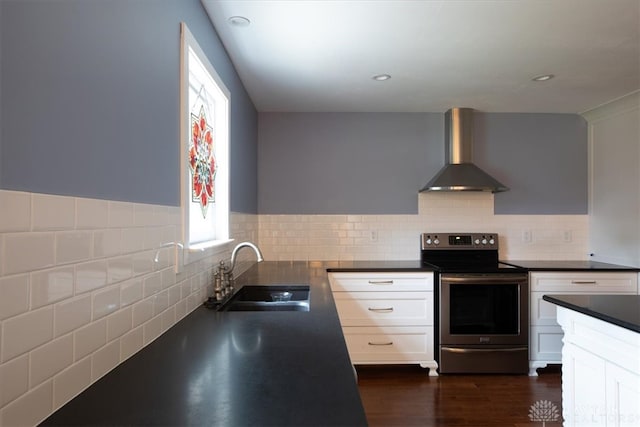 kitchen featuring white cabinets, sink, electric stove, and wall chimney range hood