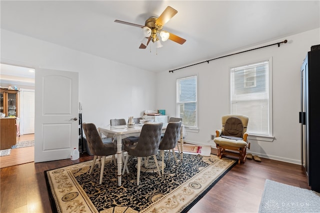 dining space featuring dark hardwood / wood-style flooring and ceiling fan