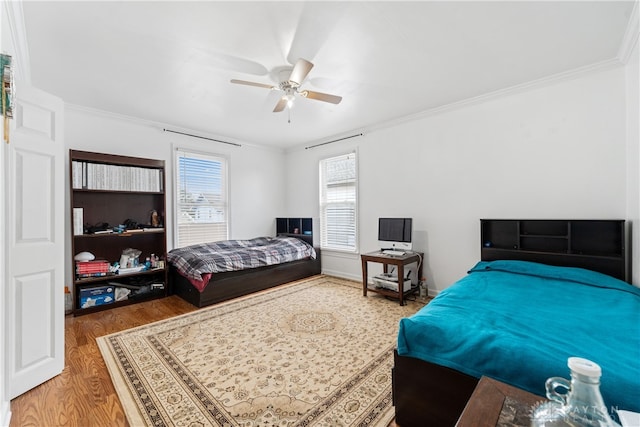 bedroom featuring wood-type flooring, ceiling fan, and crown molding