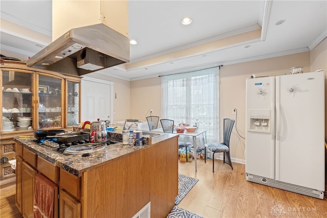 kitchen featuring stainless steel gas cooktop, light hardwood / wood-style flooring, white refrigerator with ice dispenser, crown molding, and island range hood