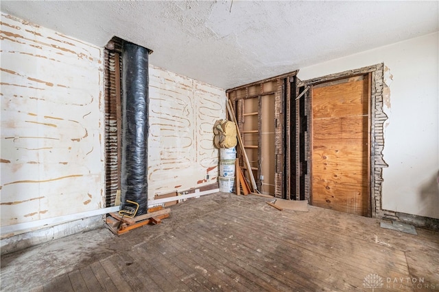 interior space featuring wood-type flooring and a textured ceiling