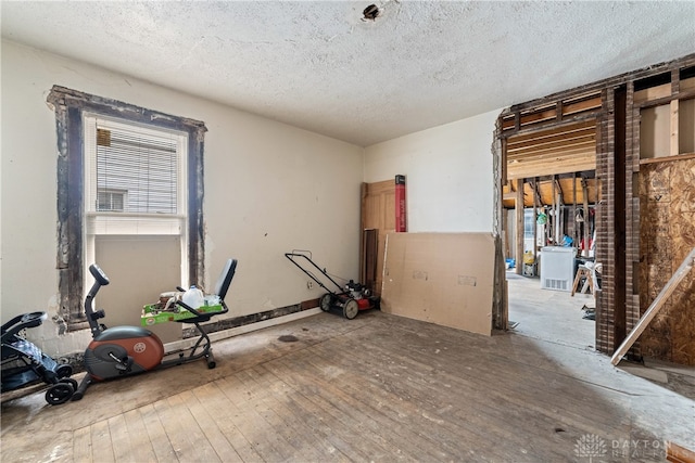 interior space with hardwood / wood-style floors and a textured ceiling