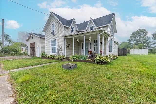 view of front facade featuring a front yard, a porch, and a garage