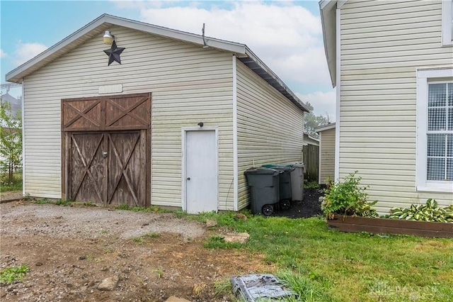 view of outbuilding featuring a yard