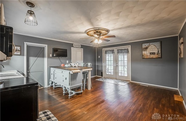 kitchen featuring sink, crown molding, dark wood-type flooring, ceiling fan, and french doors