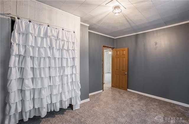 unfurnished bedroom with ornamental molding and carpet