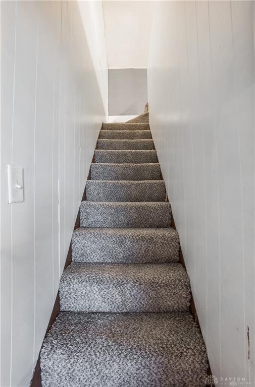 stairway with wood walls