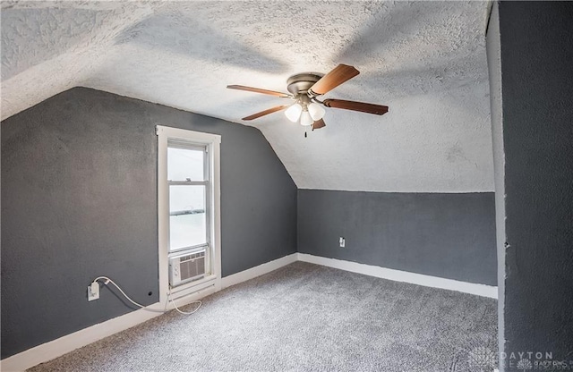 additional living space featuring lofted ceiling, carpet flooring, cooling unit, ceiling fan, and a textured ceiling