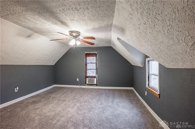 additional living space featuring carpet flooring, ceiling fan, vaulted ceiling, and a textured ceiling