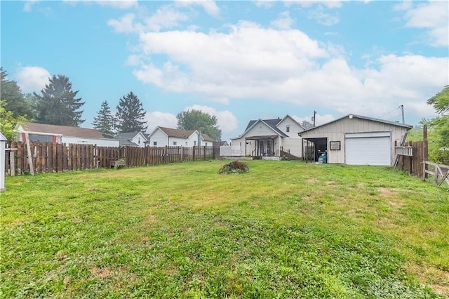 view of yard featuring a garage and an outdoor structure