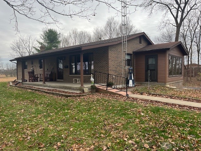 rear view of house featuring a lawn