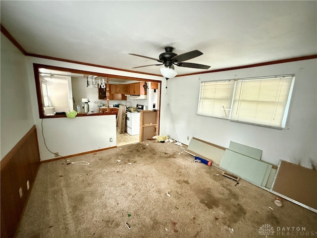 interior space featuring carpet flooring, ceiling fan, and ornamental molding