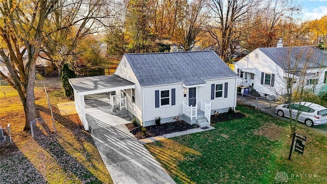 bungalow with a carport and a front lawn