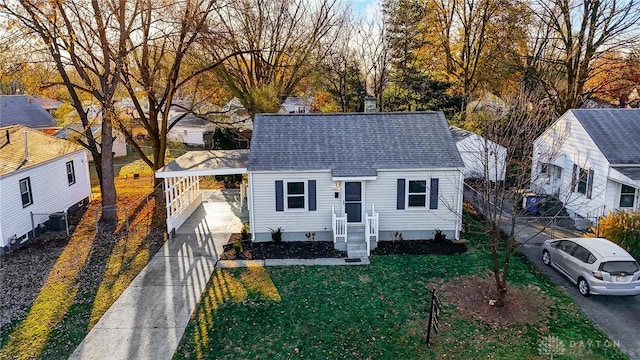 bungalow featuring cooling unit and a front yard