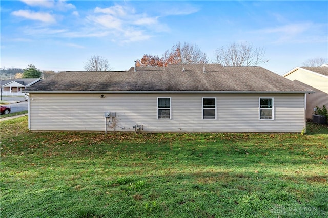 view of home's exterior featuring central air condition unit and a lawn