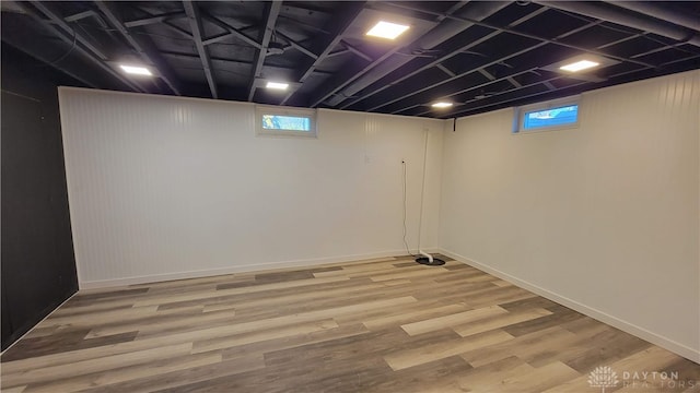 basement featuring wood-type flooring and a wealth of natural light