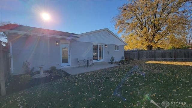 back of house featuring a yard and a patio