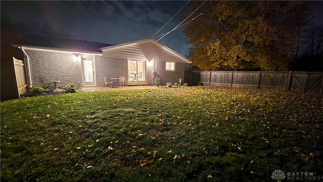 rear view of house featuring a yard