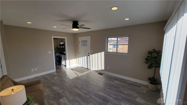 empty room with dark hardwood / wood-style floors and ceiling fan