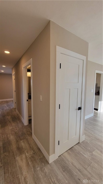 hallway with light hardwood / wood-style flooring