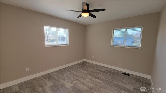 unfurnished room featuring ceiling fan and hardwood / wood-style floors