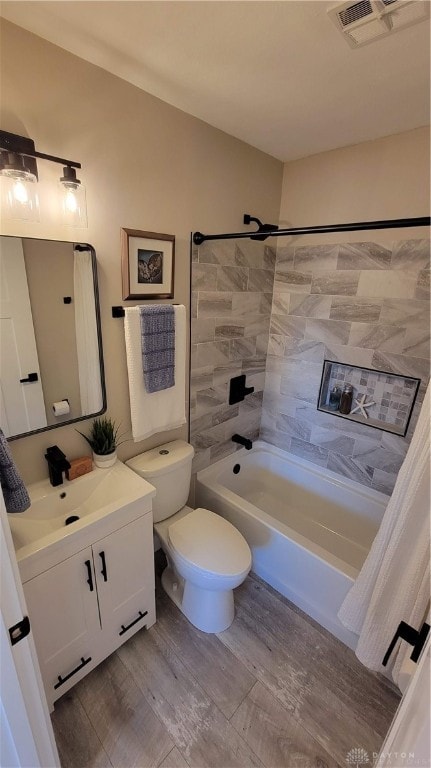 full bathroom featuring toilet, shower / tub combo with curtain, vanity, and hardwood / wood-style flooring