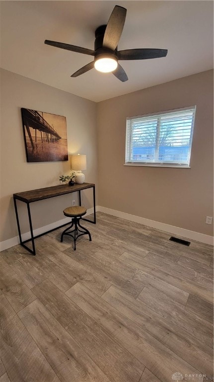 home office featuring light hardwood / wood-style flooring and ceiling fan