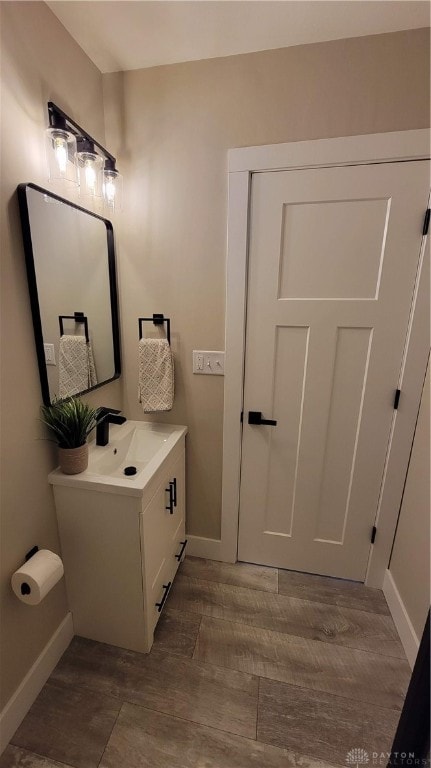 bathroom with vanity and hardwood / wood-style flooring